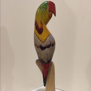 Hand carved and painted wooden parrot on perch.